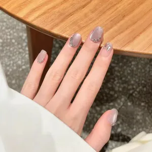Sparkling light purple cat eye press-on nails with silver glitter and crescent moon rhinestones