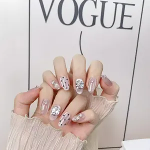 Handmade cat eye press-on nails with luxury rhinestones and polka dots on long round tips
