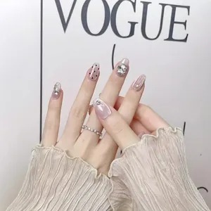 Elegant cat-eye press-on nails in dusty pink with rhinestones, pearls and wavy lines