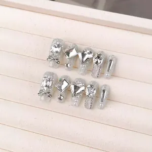Sparkling handmade silver press-on nails with luxury rhinestones and 3D bows