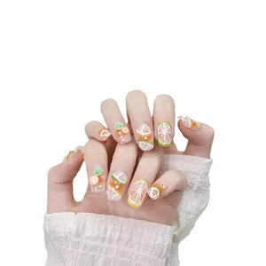 Handmade citrus-themed press-on nails with 3D lemon slices and orange jelly finish