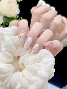 Detail of handmade press-on nails with 3D butterflies, cat eye gradient, and rhinestones