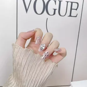 Handmade press-on nails with silver mirror finish, heart rhinestones, and black dots