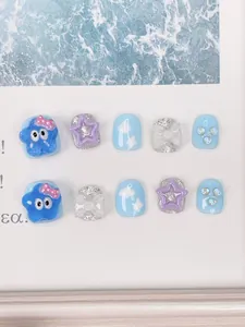 Detailed view of handmade light blue press-on nails with 3D bows and silver glitter accents