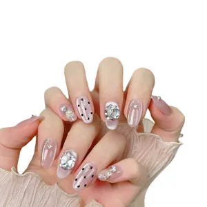 Cat eye press-on nails set with 3D rhinestones and hand-painted dots on oval shape
