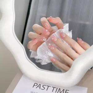 Pink gradient press-on nails with silver rhinestones and pearls on long coffin shape