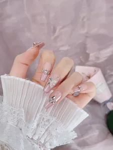 Detailed view of long coffin press-on nails with 3D butterflies and sparkling rhinestones