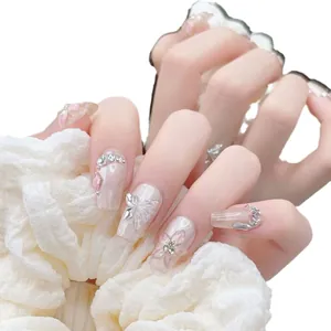 Handmade press-on nails featuring 3D white butterflies and pink floral rhinestones