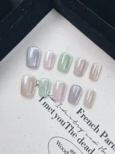 Macro detail of 10pcs handmade rainbow cat-eye press-on nails in pastel macaron shades