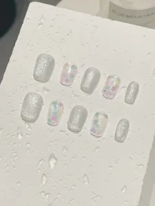 Detailed view of handmade short press-on nails with silver cat-eye glitter and sequins