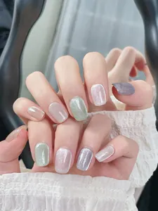 Detailed view of colorful cat-eye press-on nails with shimmering glitter finish