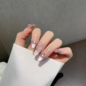 Pink cat-eye press-on nails with 3D butterfly and rhinestone accents in coffin shape