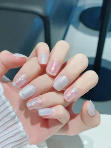 Detail of short square-oval nails with silver shimmer and colorful glitter flakes