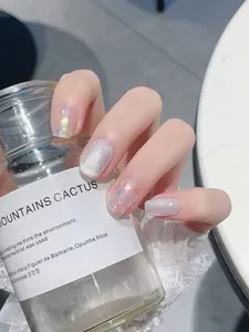 Detail of silver glitter and heart sequin cat-eye press-on nails on hands