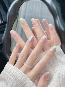 Cat eye press-on nails with colorful shimmer and gradient finish in a short square shape