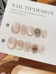 Detail of pink cat-eye press-on nails with shiny rhinestones on a display card
