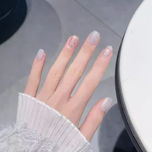 Sparkling cat-eye press-on nails with silver glitter and milky white gradient finish