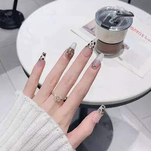 Faux ongles faits main motif léopard avec pierres ambre et design French cat-eye