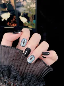 Detail of blue cat-eye nails with dragon eye design and black lace sleeve accent