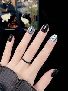 Macro shot of blue cat-eye nails and black glossy finish in short square-oval shape