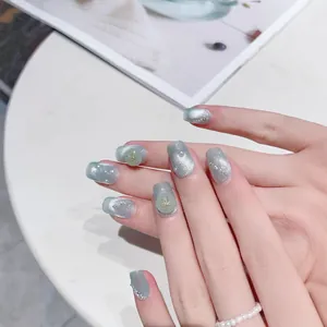 Handmade grey cat-eye press-on nails with 3D pearls and gold bowknot ornaments