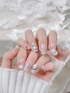 Detailed close-up of handmade press-on nails with 3D crystal butterflies and cat eye finish