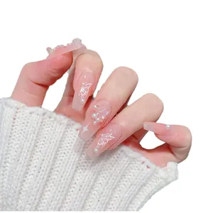 Pink coffin press-on nails with 3D butterflies, white pearls and hand-painted star motifs