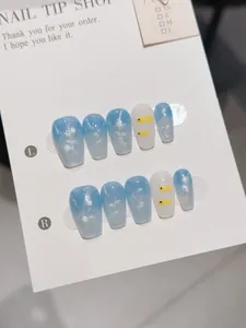 Detailed view of ocean-themed handmade blue cat-eye nails with silver glitter and fish