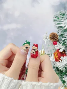 Detail of Christmas press-on nails with 3D resin bears, bows and snowflake art