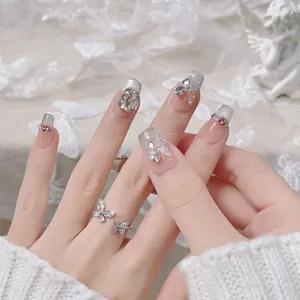 Handmade French cat eye press-on nails with white butterfly art and sparkling rhinestones