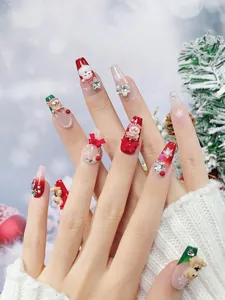 Close-up of 3D Christmas press-on nails with Santa Claus, snowman, and reindeer charms