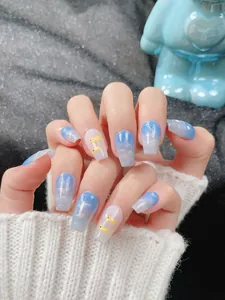 Detailed view of blue ombre coffin press-on nails with silver glitter and cute duck patterns