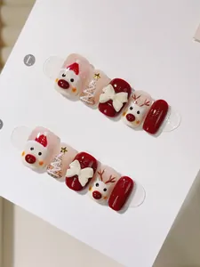Detail of handmade Christmas press-on nails with 3D bows and Santa Claus painted patterns