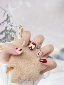 Close-up of handmade Christmas nails featuring 3D bows, Santa Claus, and reindeer art