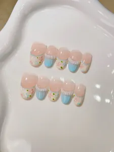 Detailed macro view of handmade press-on nails with 3D floral accents and french tips