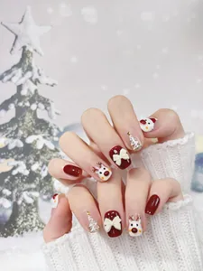 Detailed close-up of handmade Christmas press-on nails with Santa and elk patterns