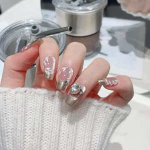 Elegant French champagne gold gradient press-on nails with white leaf art and rhinestones