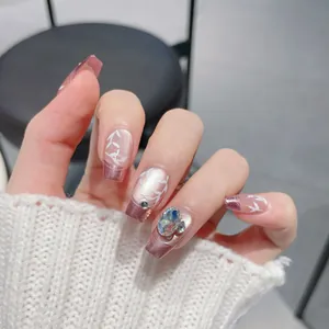 Pink gradient press-on nails with hand-painted leaves and large oval rhinestone