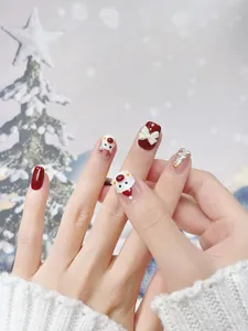 Detail of 3D Christmas press-on nails featuring Santa, reindeer, and bow relief designs