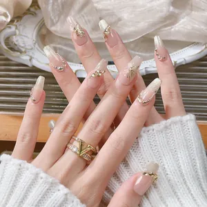 Champagne cat eye press-on nails with golden butterfly and sparkling glitter accents