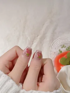 Macro shot of pink cat eye nails featuring 3D strawberry charms and square shape design