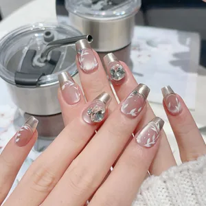 Luxurious handmade press-on nails with silver French tips, rhinestones and leaf motifs