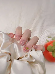 Detailed view of handmade 3D strawberry nail art with cat-eye effect on short square nails