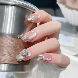 Handmade press-on nails with long square shape and French champagne gold tips