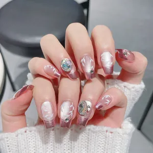 Handcrafted French pink gradient press-on nails with white leaf veins and 3D rhinestones