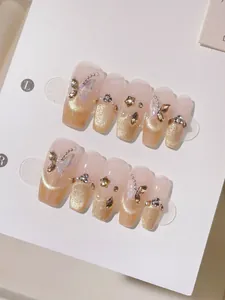 Detailed view of long coffin press-on nails with champagne cat-eye glitter and 3D butterfly