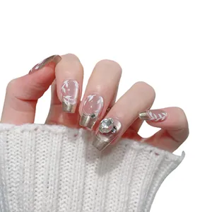 Luxurious handmade French press-on nails with gold glitter edges and crystal rhinestones