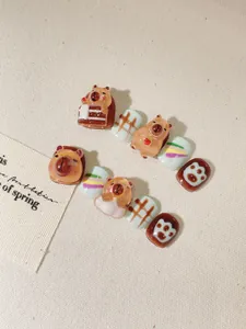 Detailed view of handmade Capybara themed press-on nails for kids with 3D resin art