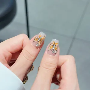 Sparkling butterfly wings press-on nails with golden glitter and diamond accents