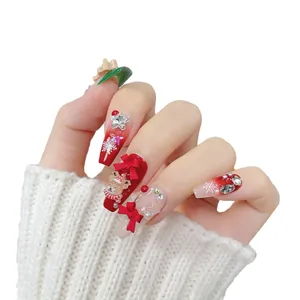 Christmas press-on nails with red bows and elk patterns on long coffin-shaped fake nails
